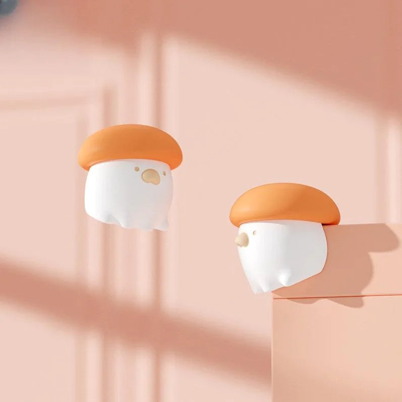 Two cartoon-like mushroom-shaped objects on a pink background
