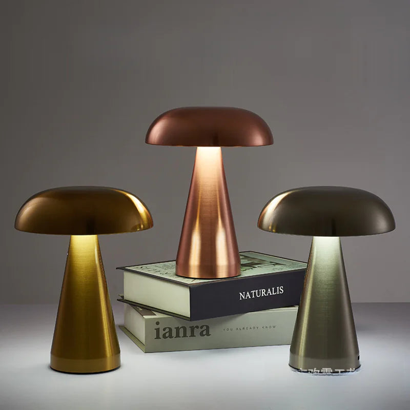 Three mushroom-shaped lamps on a gray surface with a neutral background