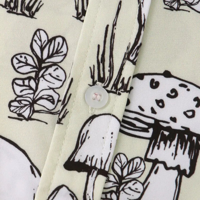 Close-up of fabric with black and white mushroom and leaf pattern on a beige background