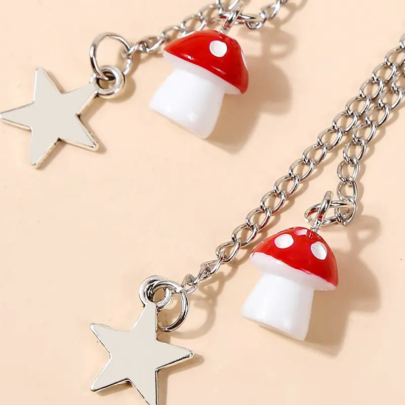 Bracelet with star and mushroom charms on a beige background