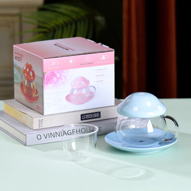 Glass mug with blue lid on a table next to its packaging