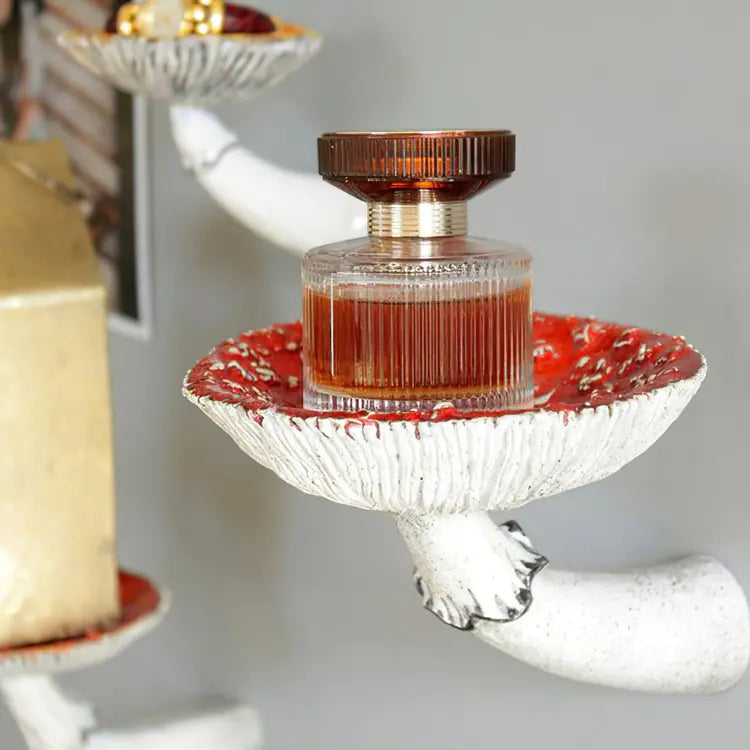 Decorative glass holder with a bottle of liquid on a white background