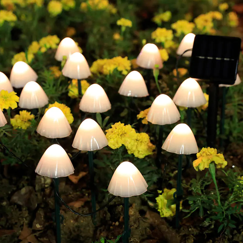 Mushroom-shaped garden lights with solar panel on a grassy background
