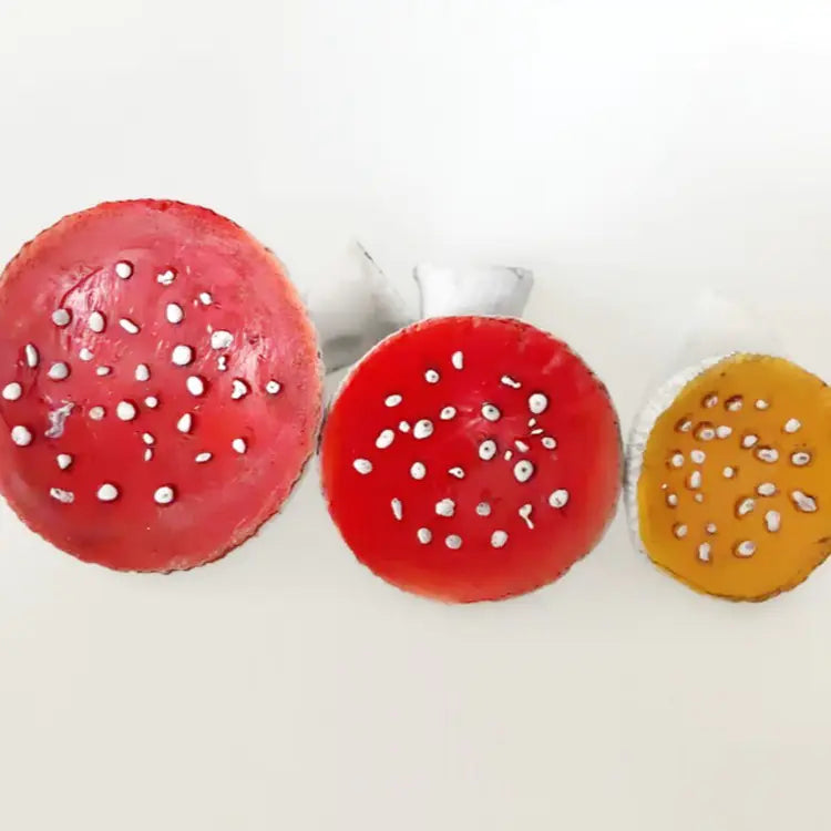 Three colorful strawberry-shaped objects on a white background