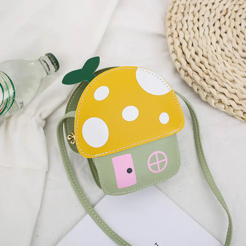 Children's mushroom-shaped purse with a strap on a light background
