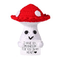 Crocheted mushroom with a red cap and white body on a white background