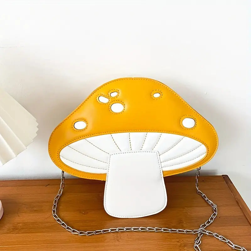 Mushroom-shaped lamp with yellow cap and white base on a wooden surface.