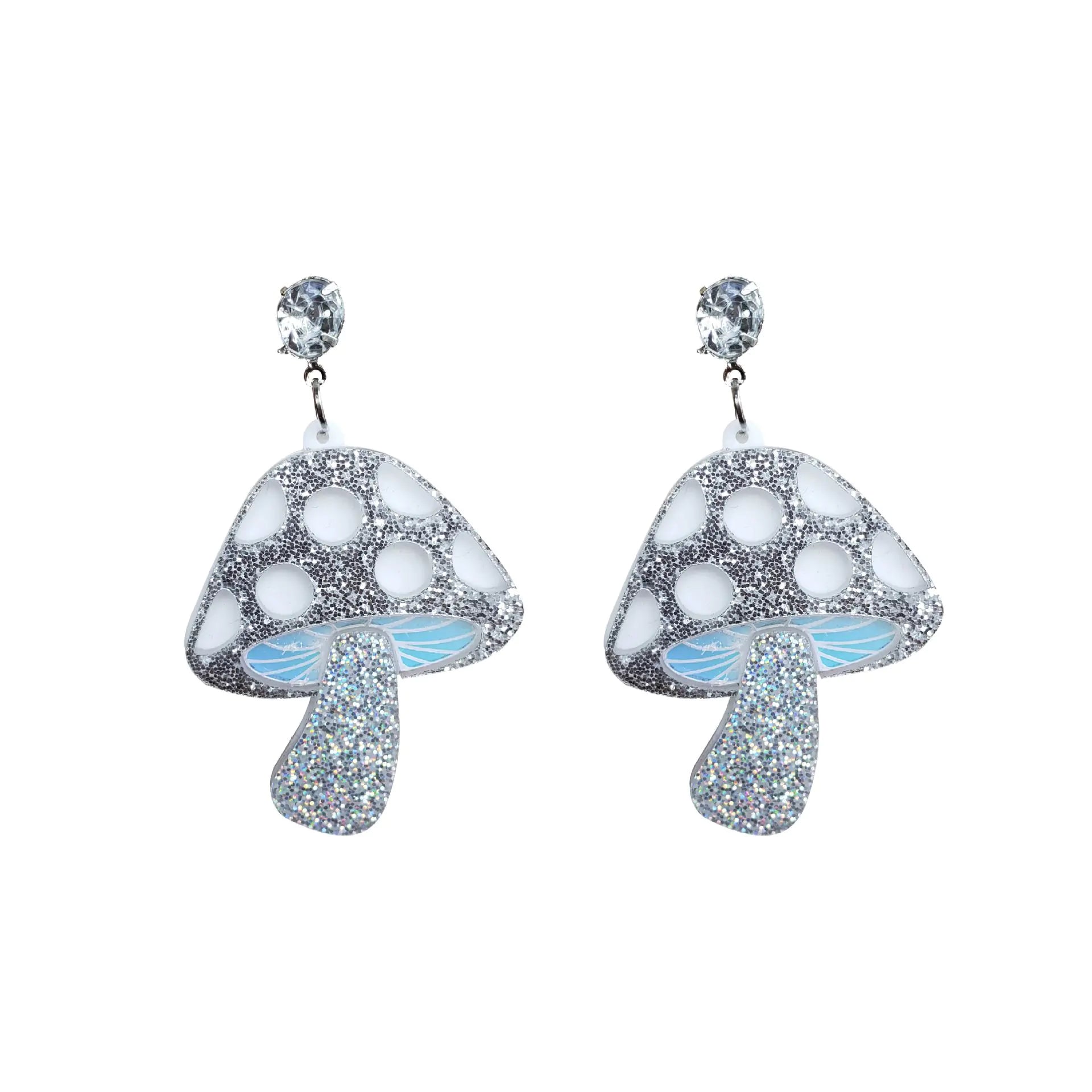 Mushroom-shaped earrings with glittery texture on a white background