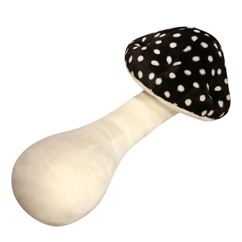 Mushroom-shaped toy with a black cap with white spots and a beige stem on a white background