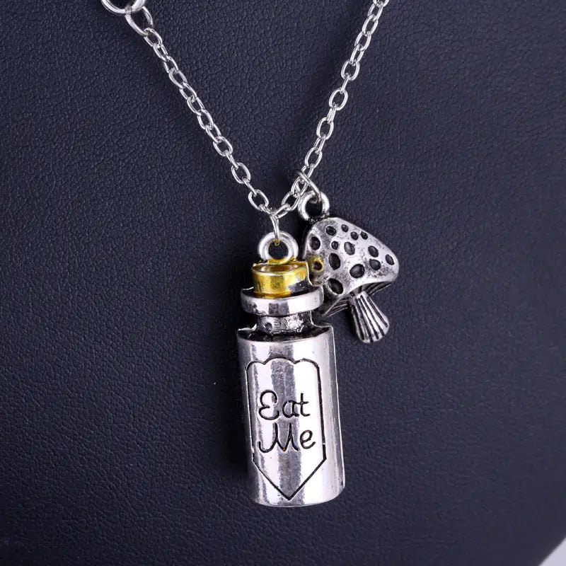 Necklace with a silver jar charm labeled 'Eat Me' on a dark background