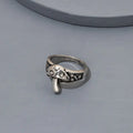 Silver ring with decorative design on a gray background